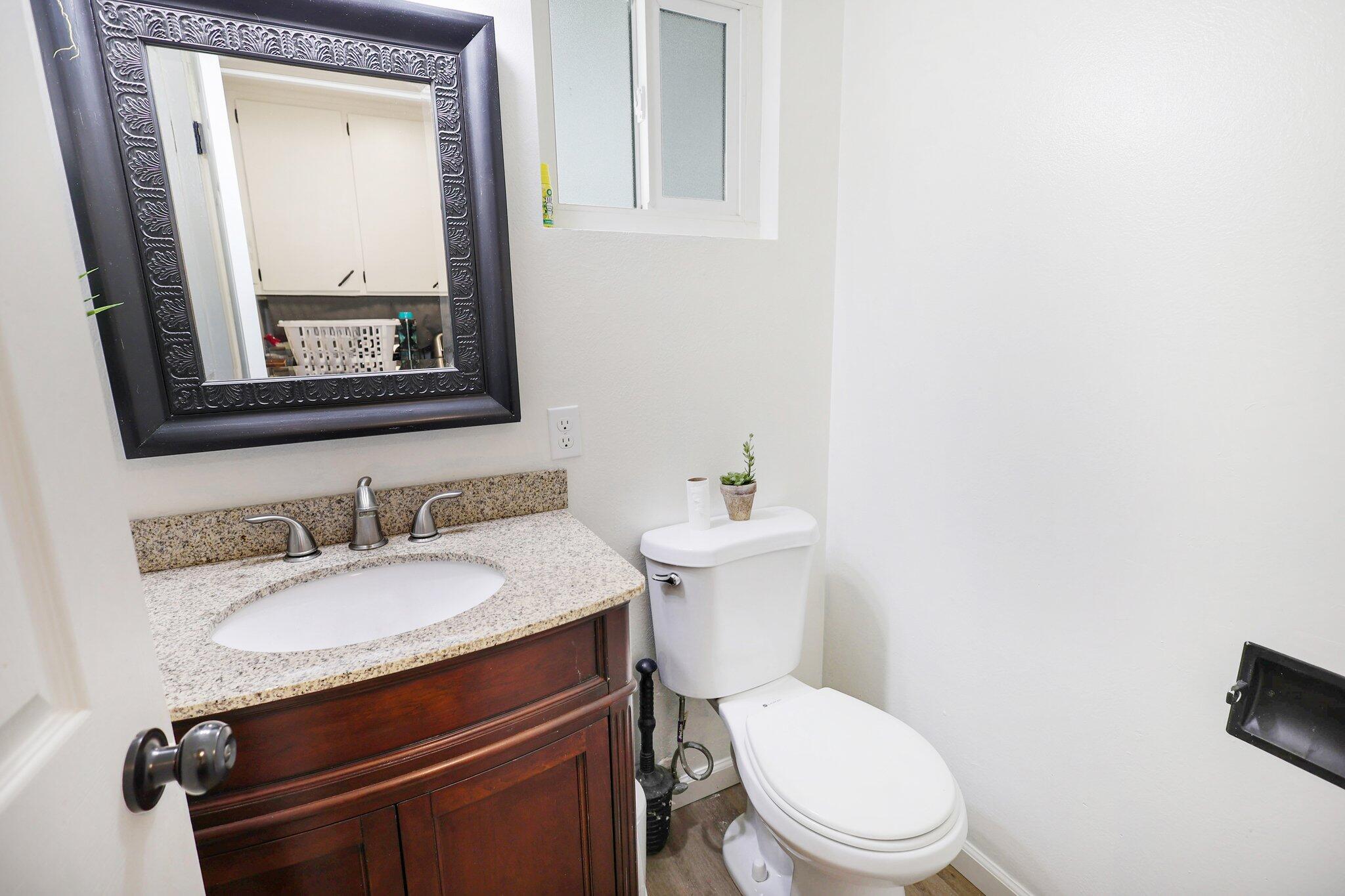 140 Chestnut Avenue Red Bluff, CA 96080 - Photo 16 of 26 a bathroom with a toilet a sink and mirror