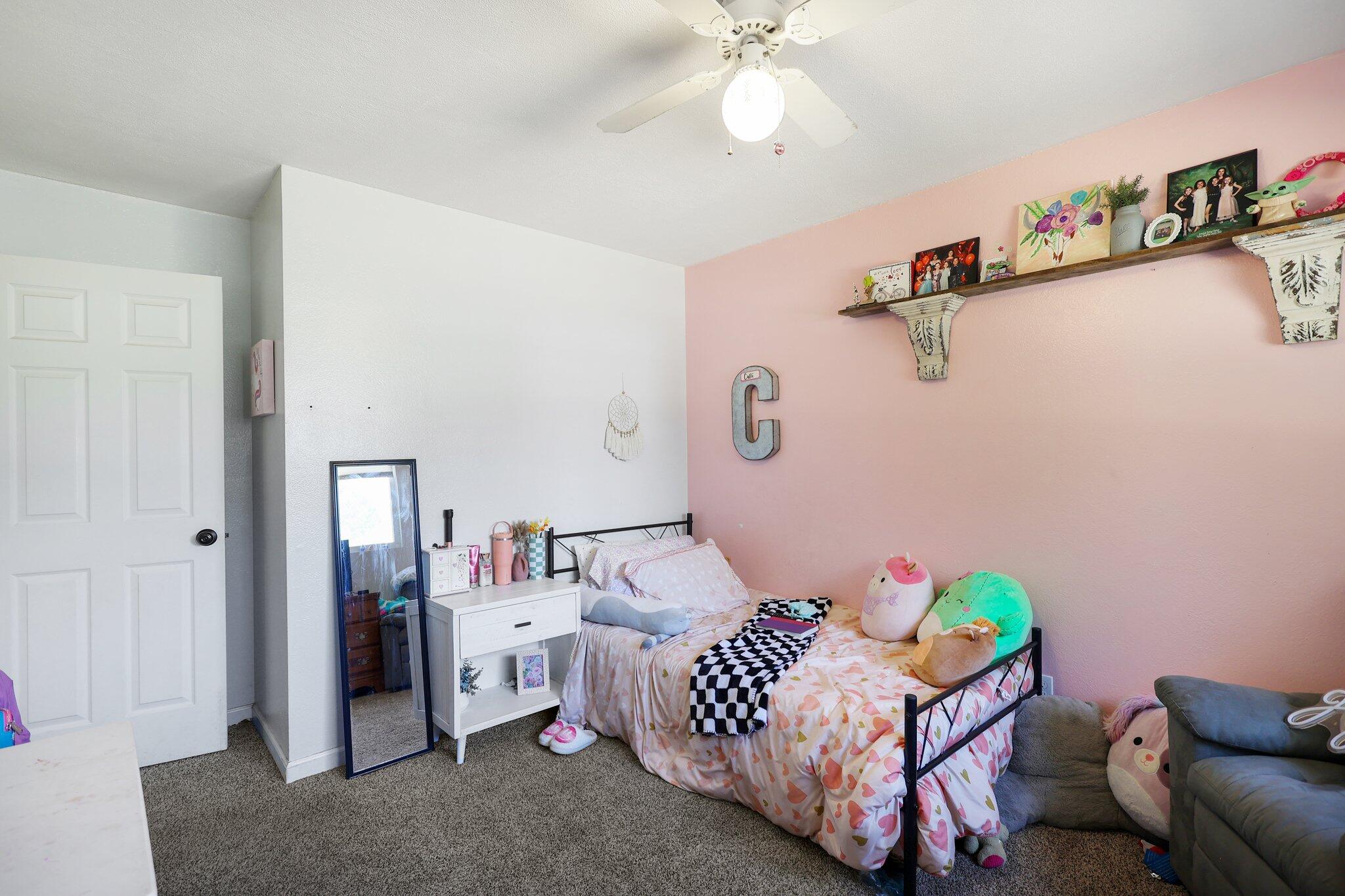 140 Chestnut Avenue Red Bluff, CA 96080 - Photo 18 of 26 a bedroom with a bed and a chandelier