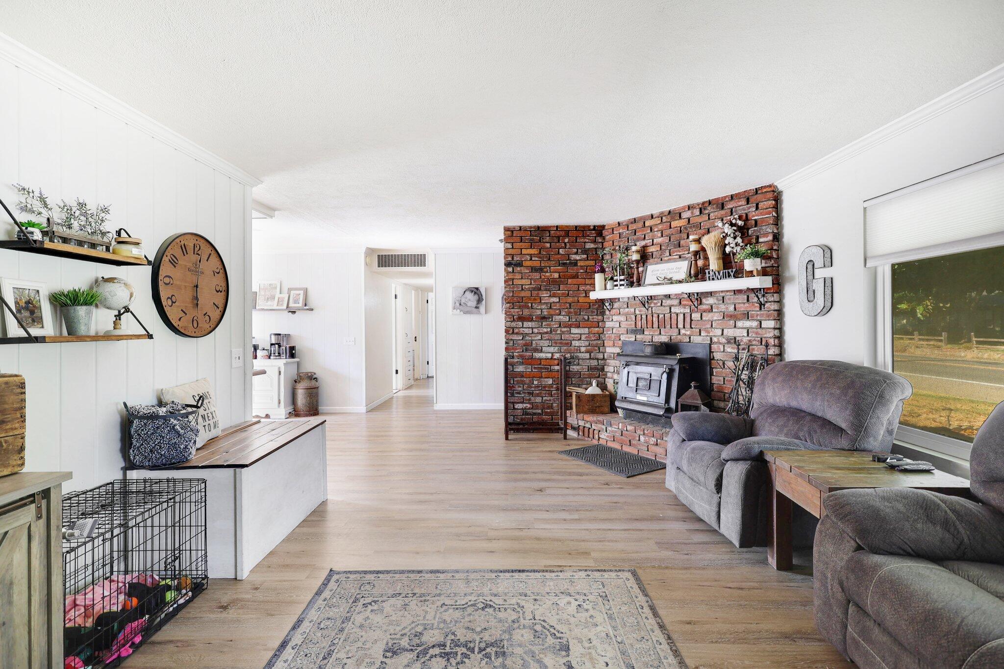 140 Chestnut Avenue Red Bluff, CA 96080 - Photo 3 of 26 a living room with furniture a fireplace and a flat screen tv