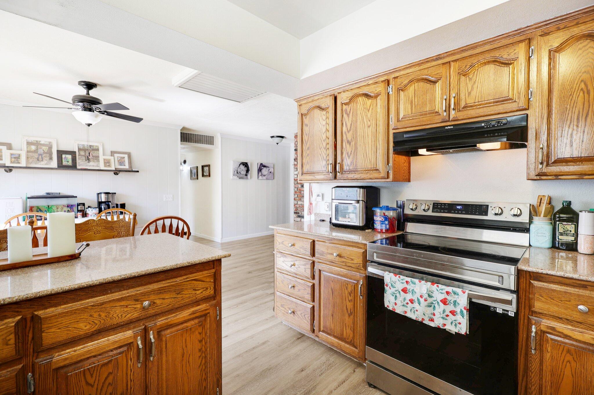 140 Chestnut Avenue Red Bluff, CA 96080 - Photo 9 of 26 a kitchen with granite countertop a stove and cabinets