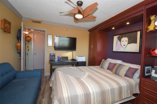 a bedroom with a bed and a flat screen tv