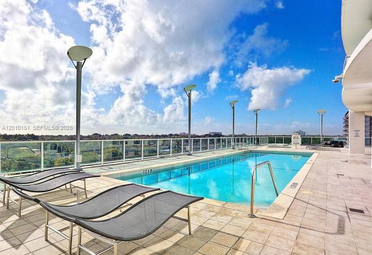 2525 Southwest 3rd Avenue, Unit 1603 Miami, FL 33129 - Photo 18 of 20 a view of a swimming pool with a lounge chairs