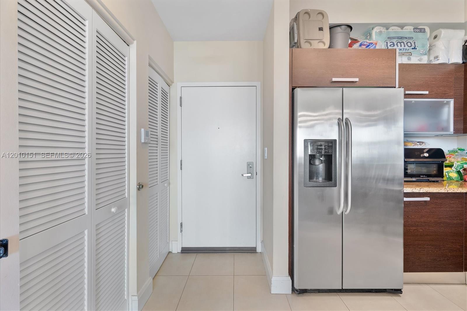 2525 Southwest 3rd Avenue, Unit 1603 Miami, FL 33129 - Photo 3 of 20 a kitchen with metallic refrigerator freezer and a dishwasher