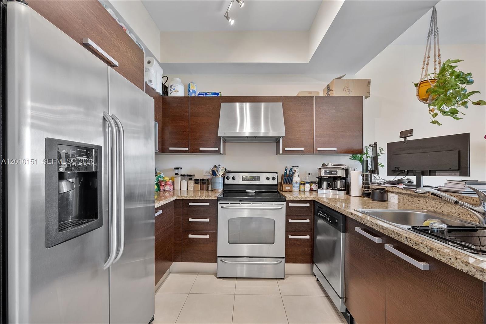 2525 Southwest 3rd Avenue, Unit 1603 Miami, FL 33129 - Photo 5 of 20 a kitchen with stainless steel appliances granite countertop a refrigerator stove and sink