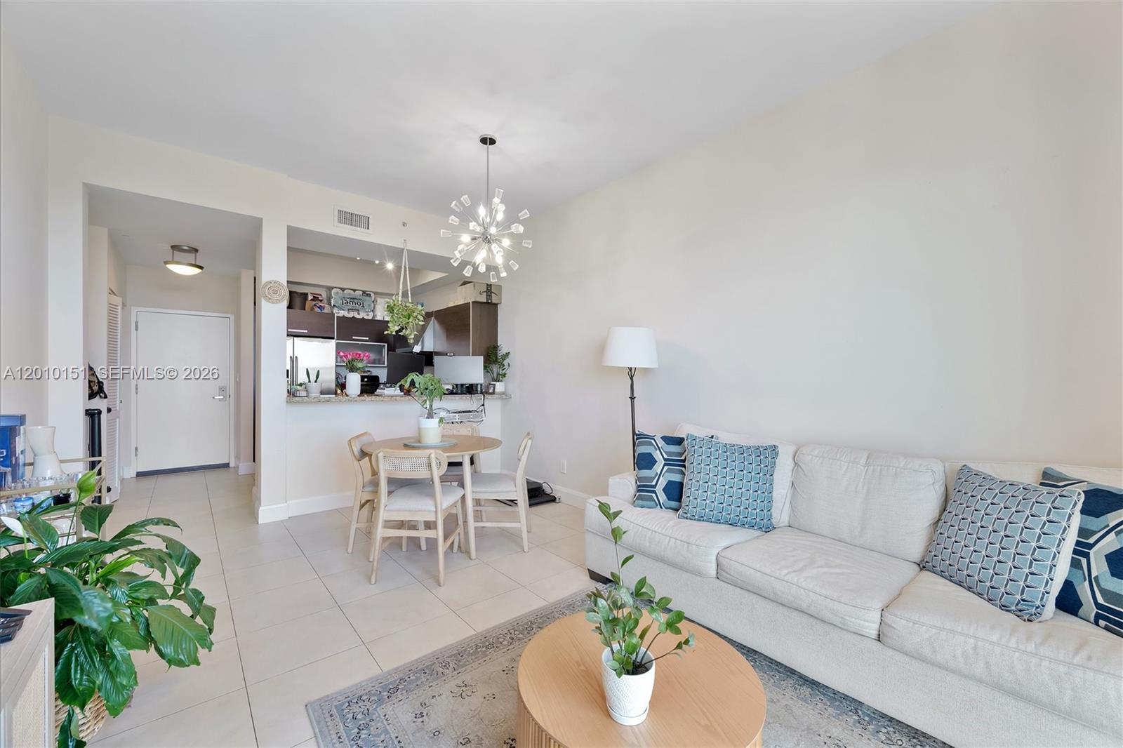 2525 Southwest 3rd Avenue, Unit 1603 Miami, FL 33129 - Photo 7 of 20 a living room with furniture and a chandelier