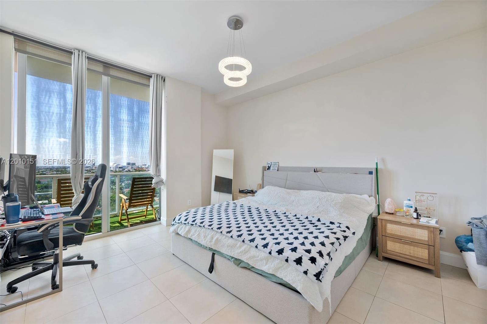2525 Southwest 3rd Avenue, Unit 1603 Miami, FL 33129 - Photo 8 of 20 a bedroom with a bed and a table