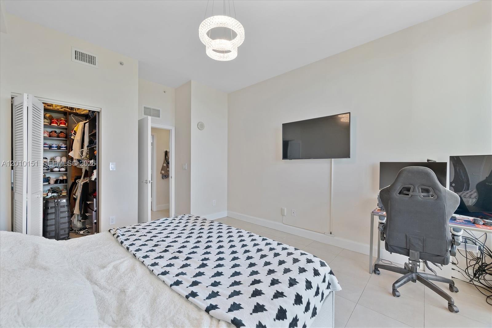 2525 Southwest 3rd Avenue, Unit 1603 Miami, FL 33129 - Photo 9 of 20 a bedroom with a bed and a chair