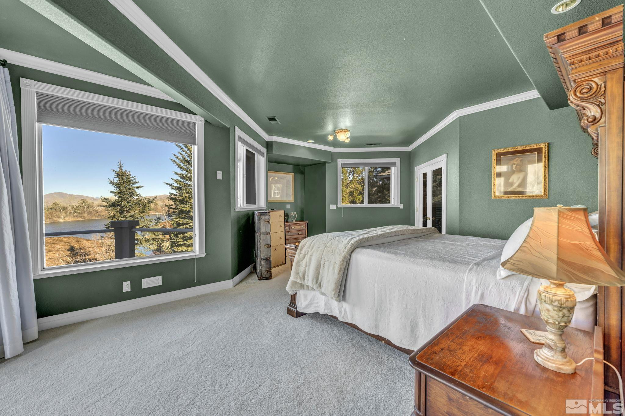 15 Hidden Lake Drive Reno, NV 89521 - Photo 14 of 40 a spacious bedroom with a bed and window