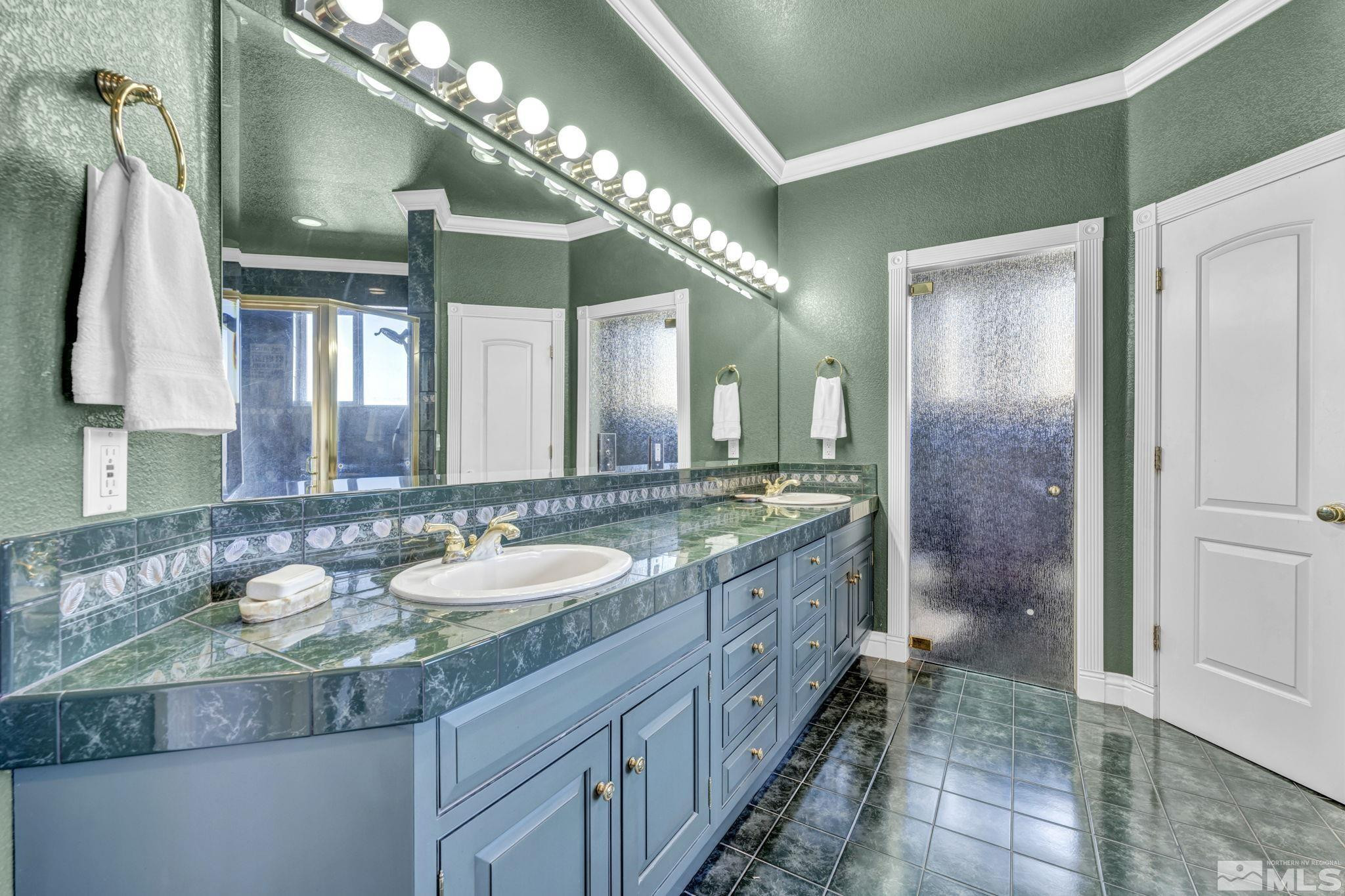 15 Hidden Lake Drive Reno, NV 89521 - Photo 18 of 40 a bathroom with a granite countertop sink a large mirror and a shower