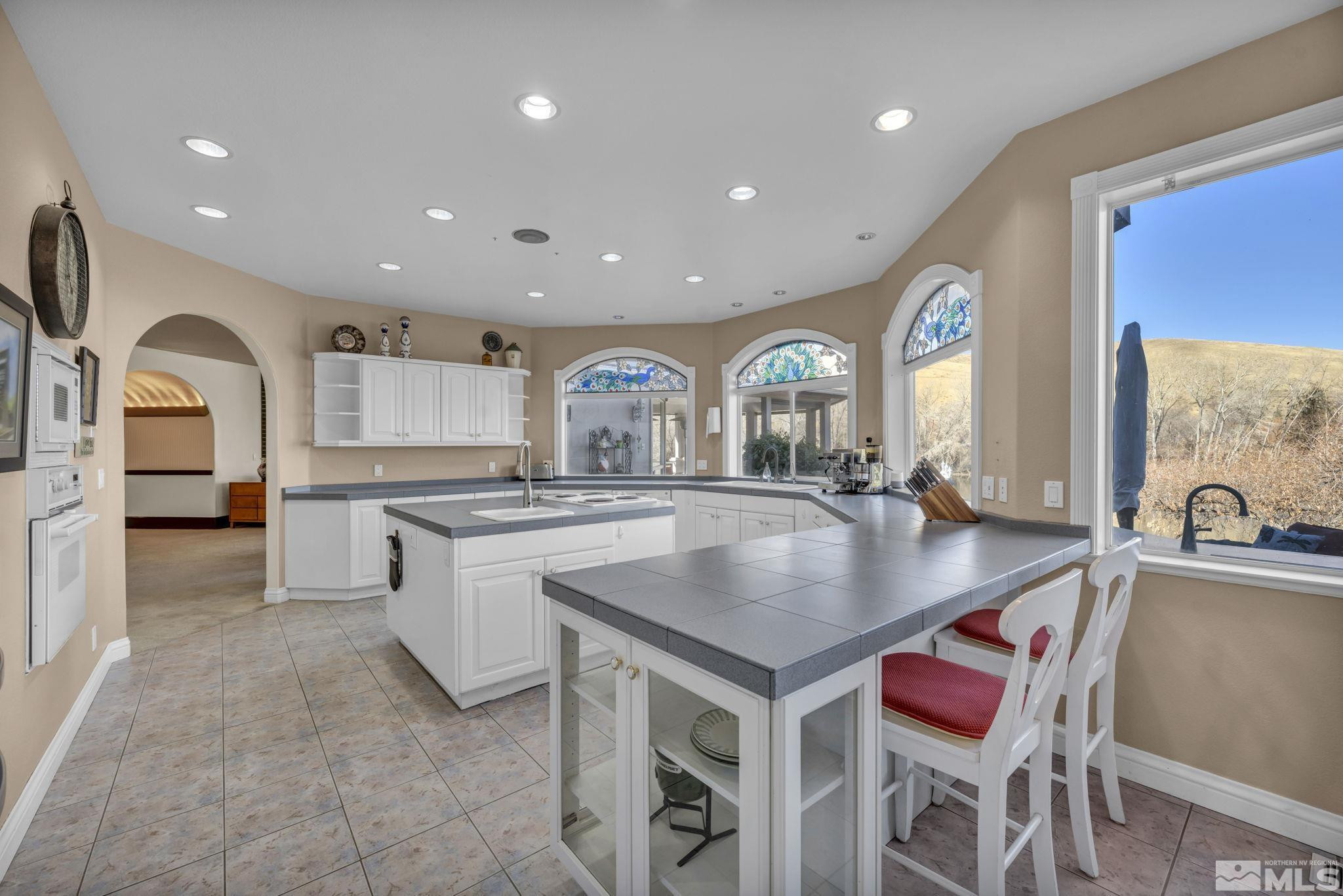 15 Hidden Lake Drive Reno, NV 89521 - Photo 29 of 40 a kitchen with center island table and chairs