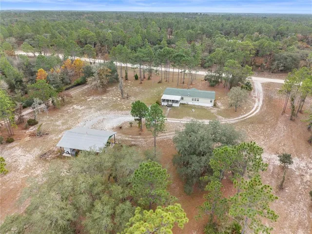 a aerial view of a houses with yard