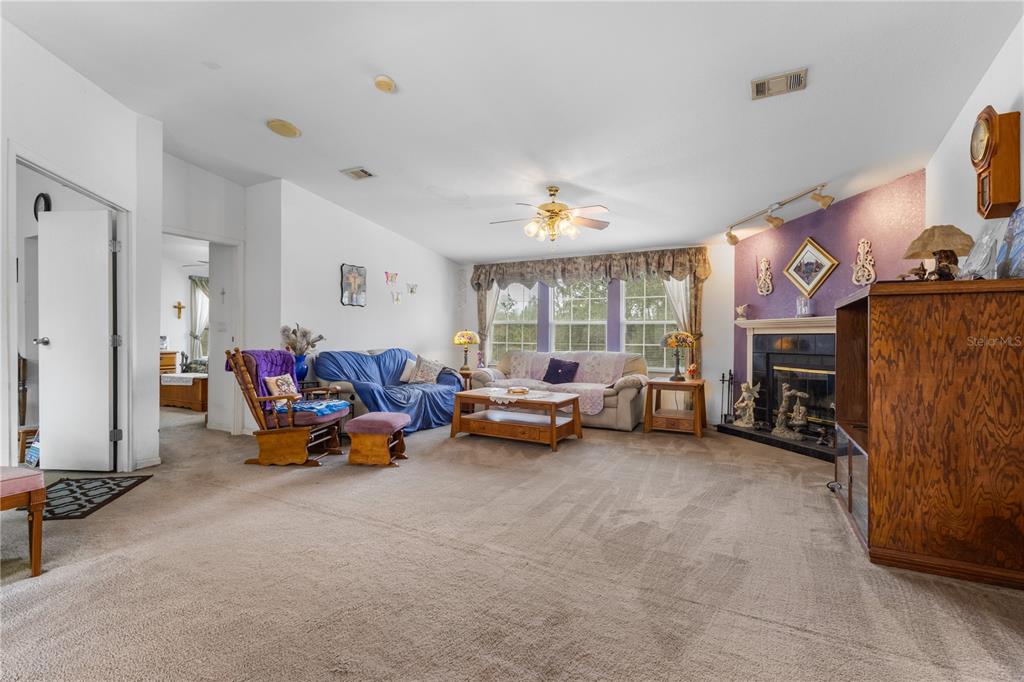 12251 Southeast 66th Place Morriston, FL 32668 - Photo 25 of 55 a living room with furniture and a fireplace