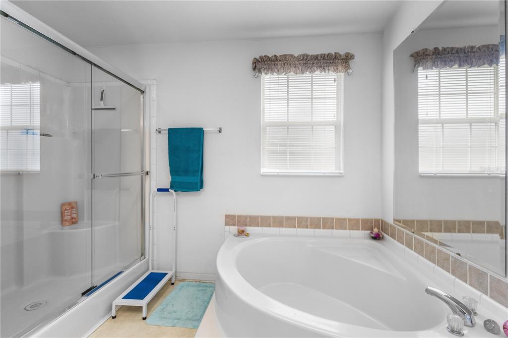 12251 Southeast 66th Place Morriston, FL 32668 - Photo 28 of 55 a bathroom with a tub a window and a shower