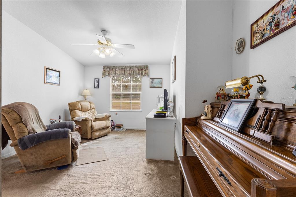 12251 Southeast 66th Place Morriston, FL 32668 - Photo 31 of 55 a living room with furniture and a chandelier