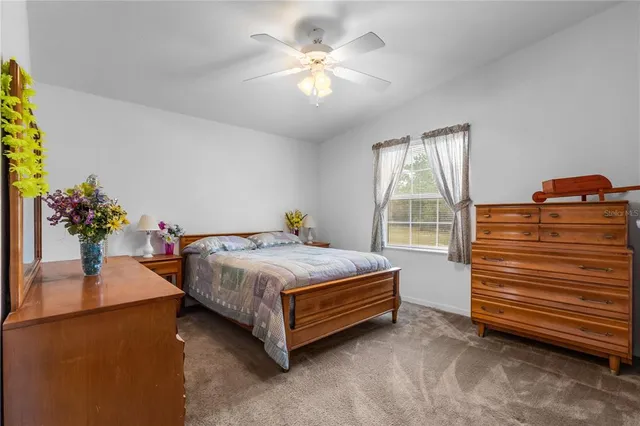 a bedroom with a bed dresser and a window