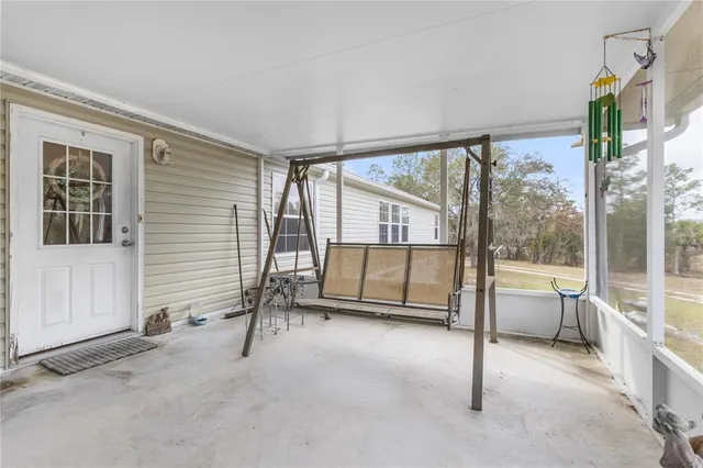 a kitchen with stainless steel appliances granite countertop a stove top oven a sink a dining table and chairs with wooden floor