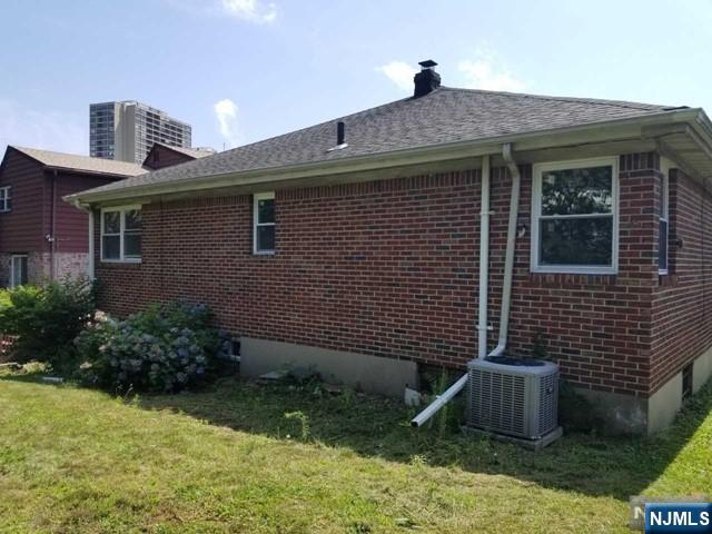 229 Mohegan Way Fort Lee, NJ 07024 - Photo 13 of 14 a front view of a house with garden