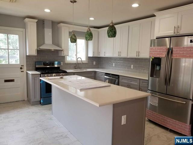 229 Mohegan Way Fort Lee, NJ 07024 - Photo 4 of 14 a kitchen with stainless steel appliances a refrigerator sink and stove