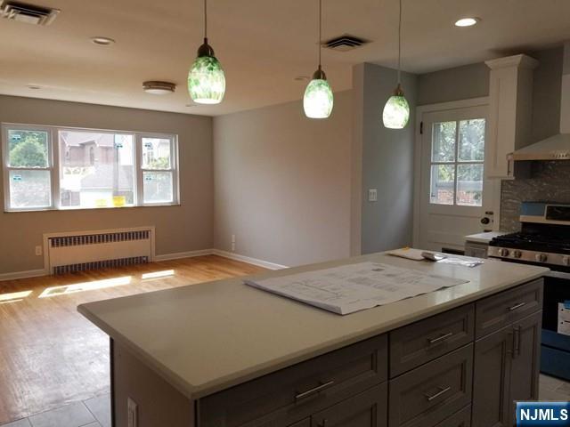 229 Mohegan Way Fort Lee, NJ 07024 - Photo 5 of 14 a kitchen with a stove a sink dishwasher and a window