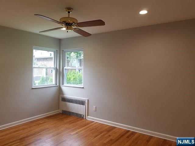 229 Mohegan Way Fort Lee, NJ 07024 - Photo 8 of 14 wooden floor in an empty room with a window