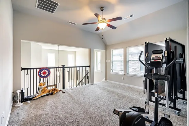 a view of gym equipment with wooden floor