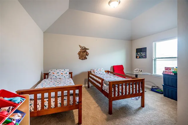 a bedroom with baby bed and a window