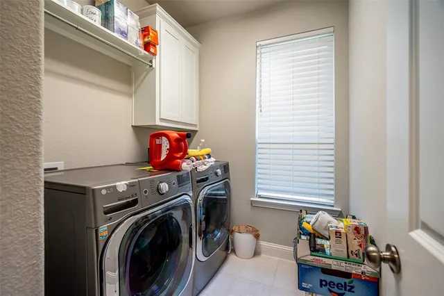 a utility room with dryer washer and a window