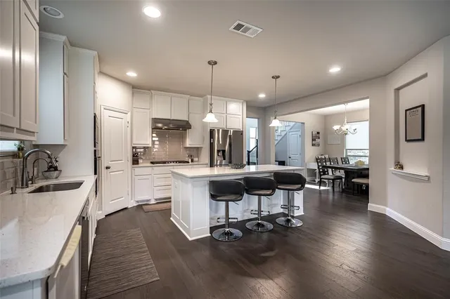 a kitchen with counter top space a sink appliances and cabinets
