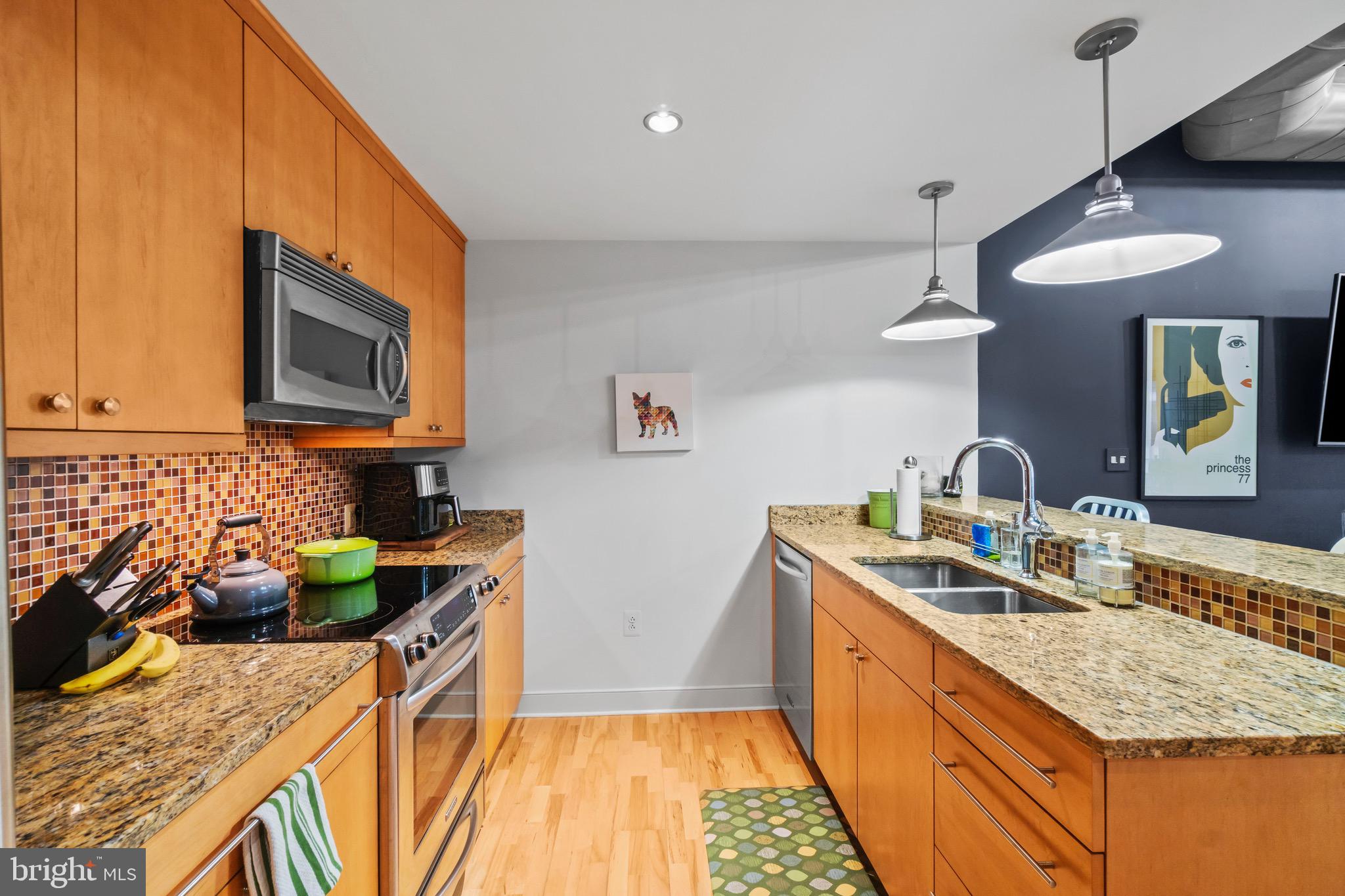 850 Aliceanna Street, Unit 604 Baltimore, MD 21202 - Photo 14 of 43 a kitchen with stainless steel appliances granite countertop a sink stove and cabinets