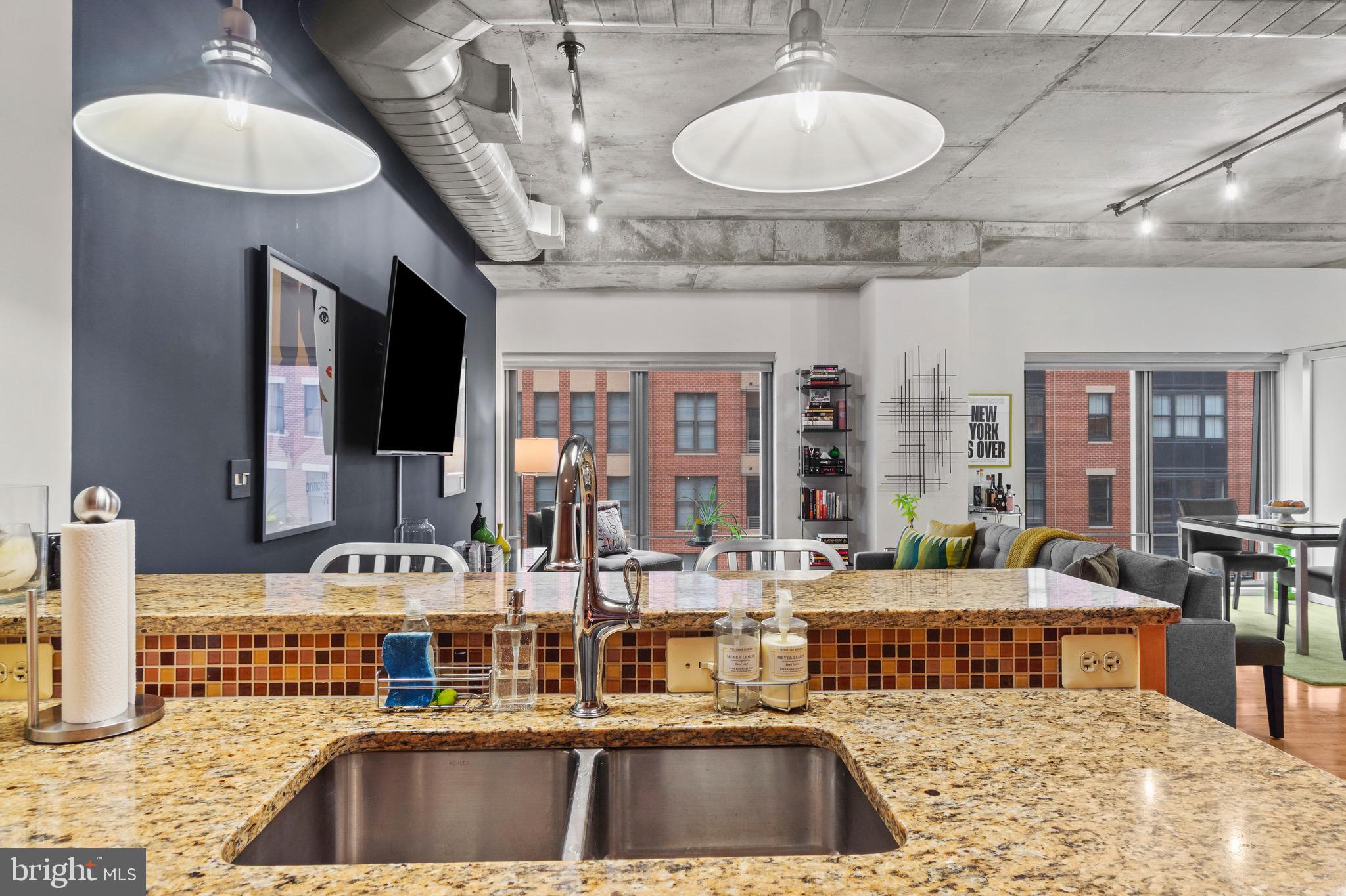 850 Aliceanna Street, Unit 604 Baltimore, MD 21202 - Photo 15 of 43 a kitchen with furniture and a flat screen tv