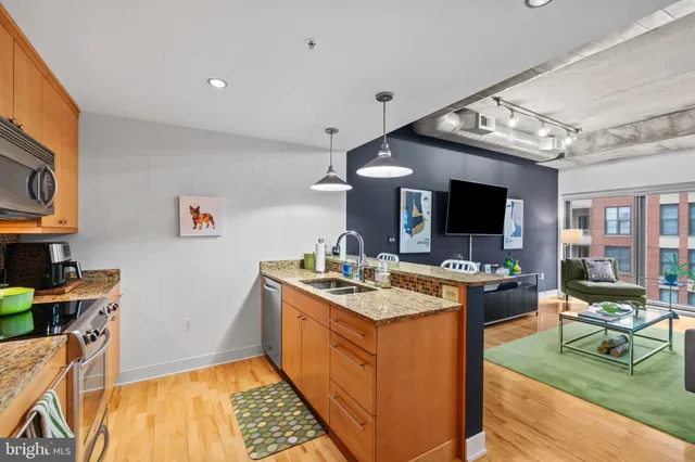 a kitchen with stainless steel appliances granite countertop a stove and a sink