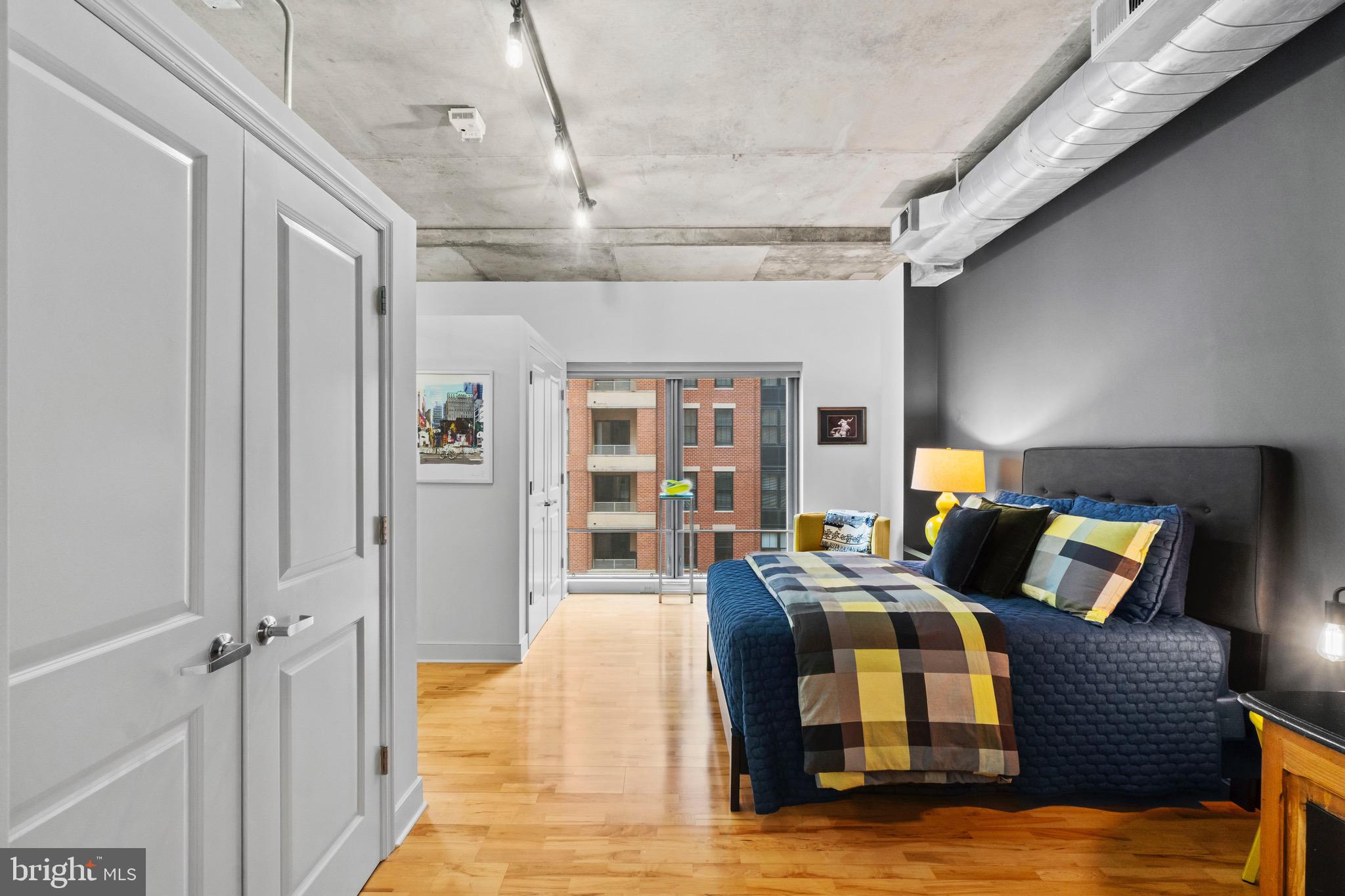 850 Aliceanna Street, Unit 604 Baltimore, MD 21202 - Photo 18 of 43 a bedroom with furniture and window