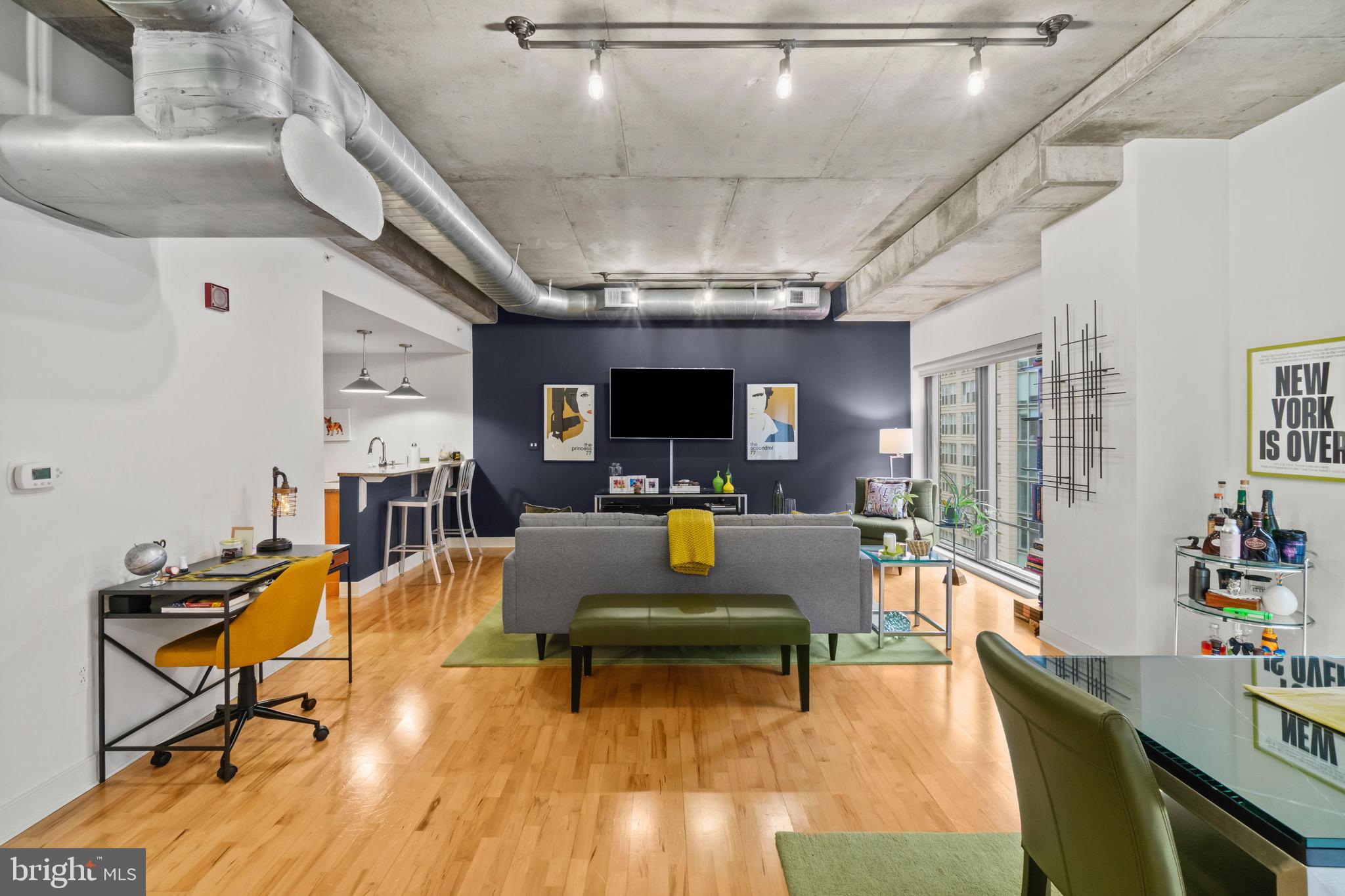 850 Aliceanna Street, Unit 604 Baltimore, MD 21202 - Photo 2 of 43 a living room with furniture and a flat screen tv