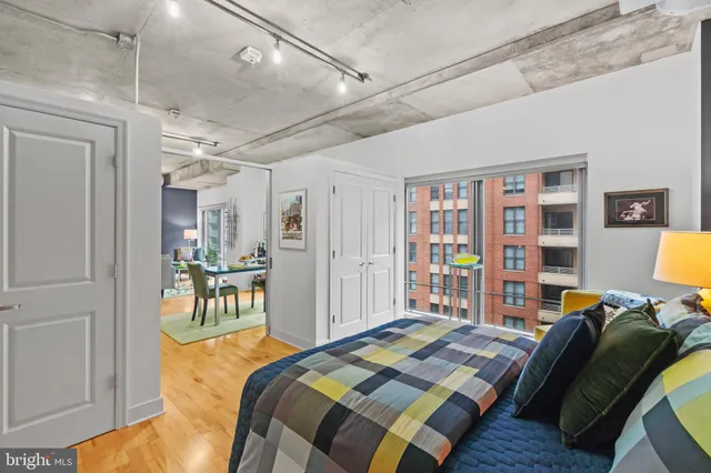 a bedroom with a bed furniture and a book shelf