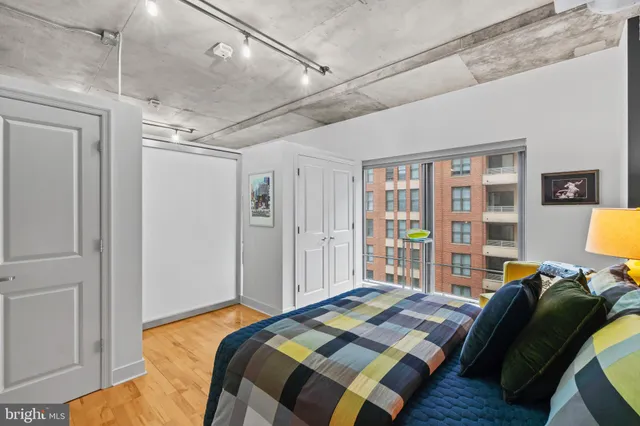 a bed sitting in a bedroom next to a window