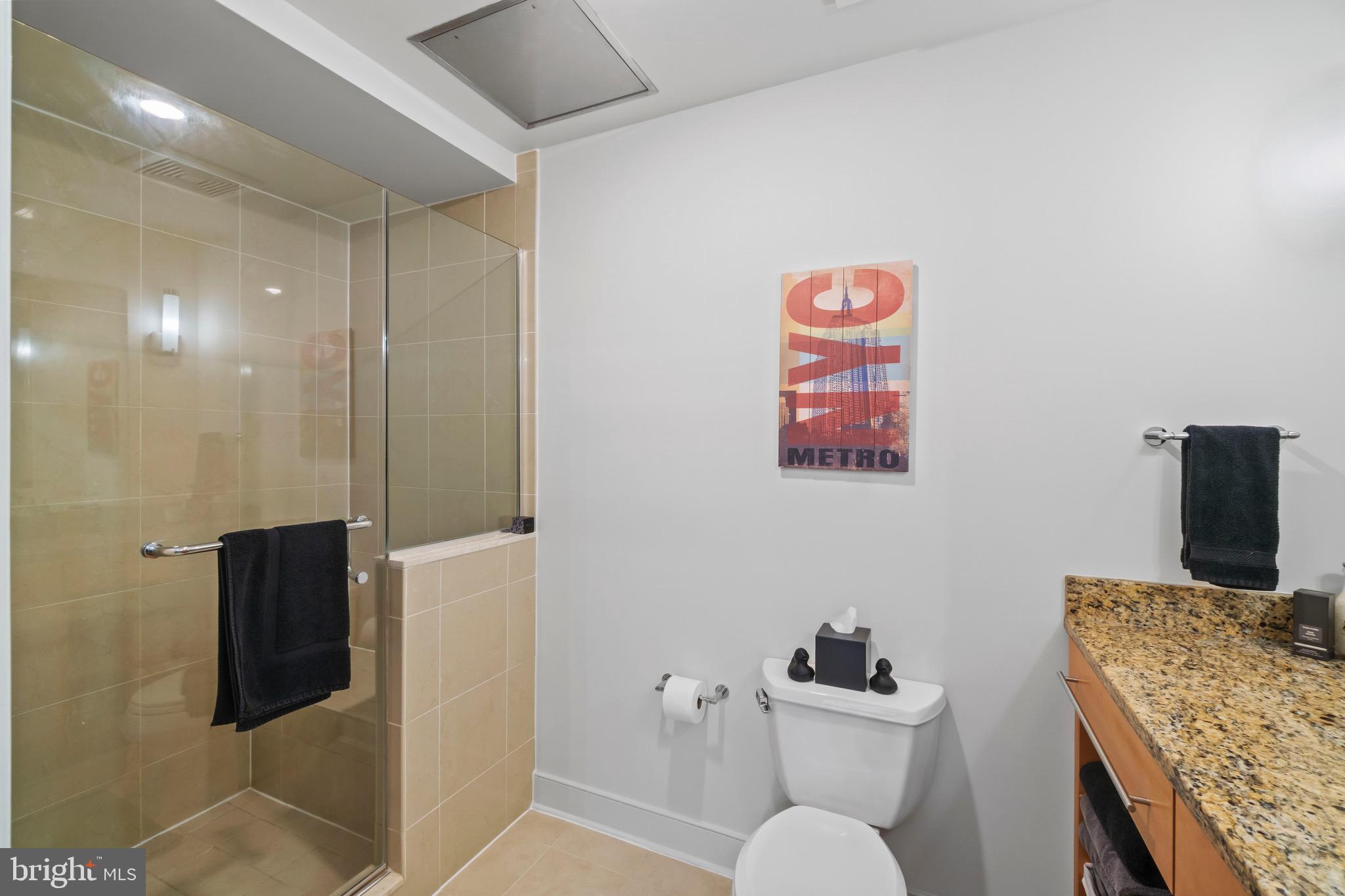 850 Aliceanna Street, Unit 604 Baltimore, MD 21202 - Photo 23 of 43 a bathroom with a sink a mirror and a toilet