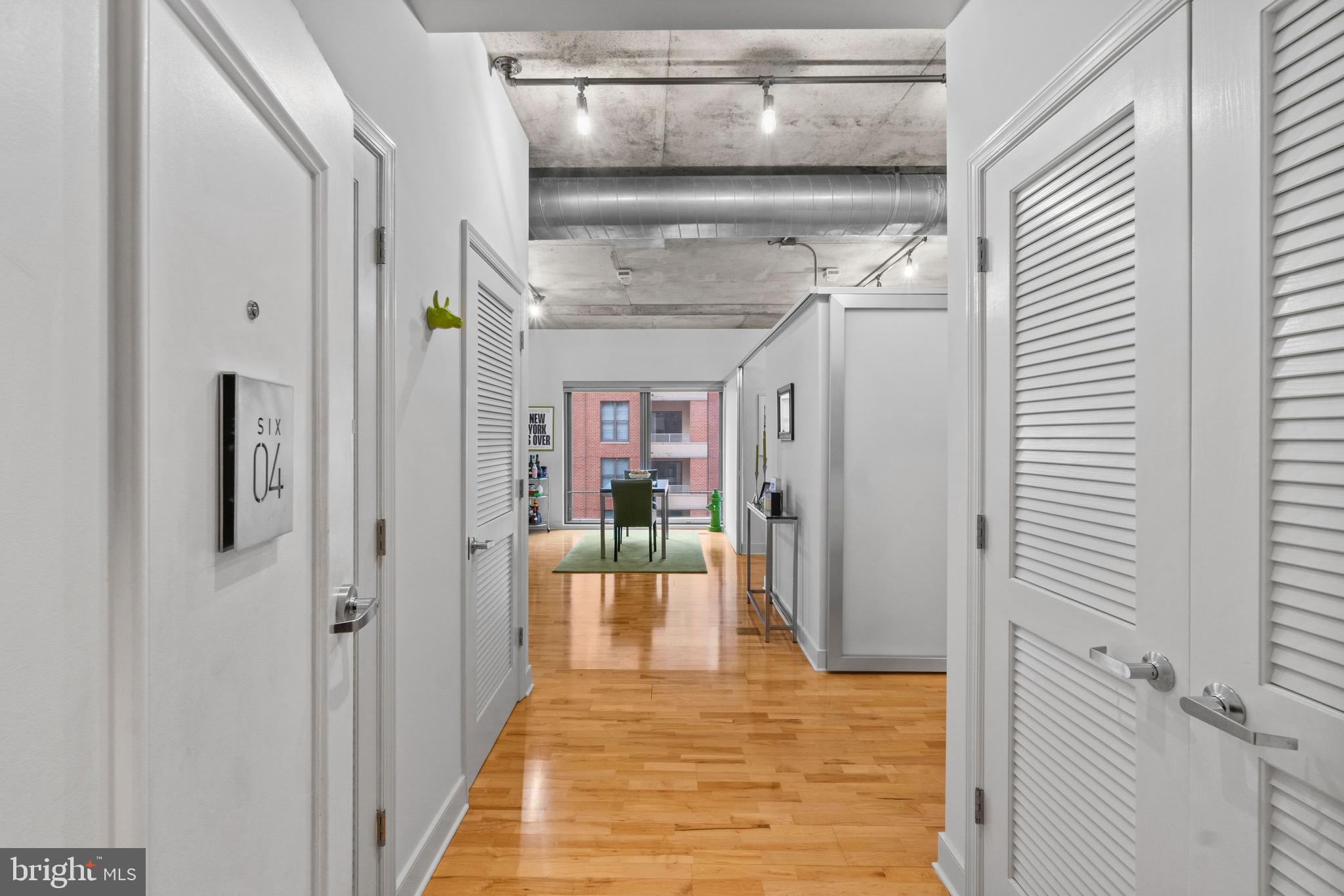 850 Aliceanna Street, Unit 604 Baltimore, MD 21202 - Photo 3 of 43 a view of a hallway with wooden floor and entryway
