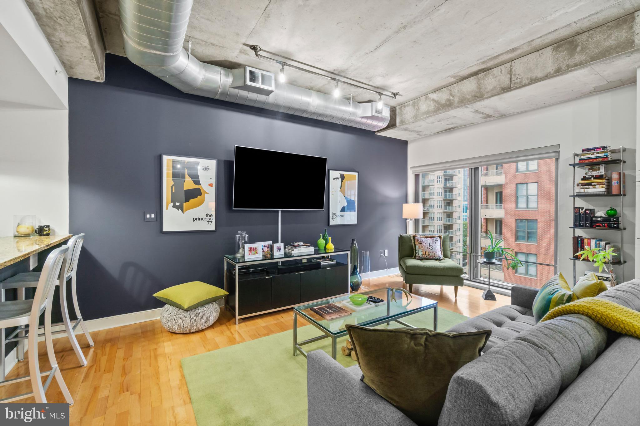 850 Aliceanna Street, Unit 604 Baltimore, MD 21202 - Photo 5 of 43 a living room with furniture and a flat screen tv