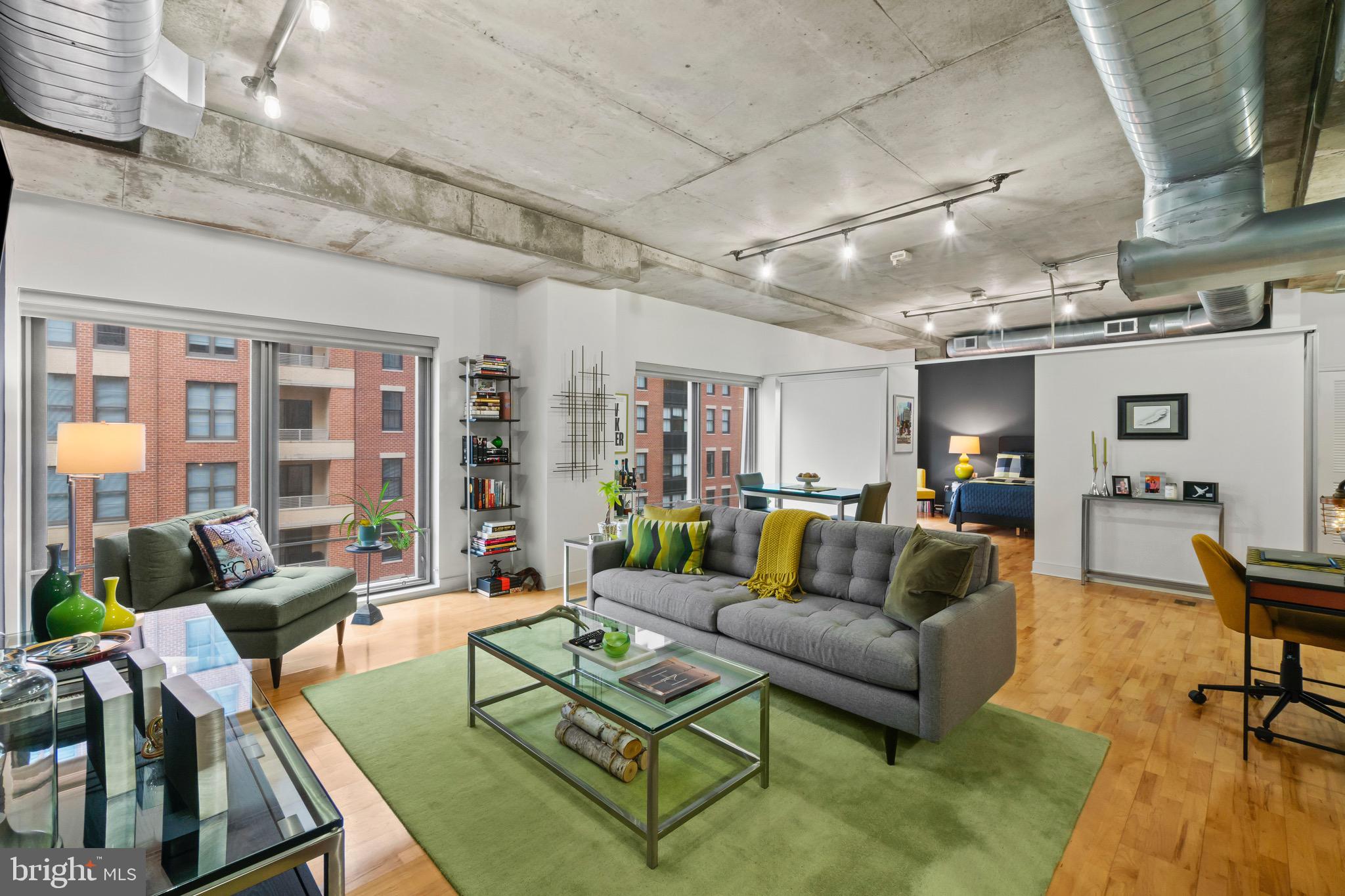 850 Aliceanna Street, Unit 604 Baltimore, MD 21202 - Photo 6 of 43 a living room with furniture and a table