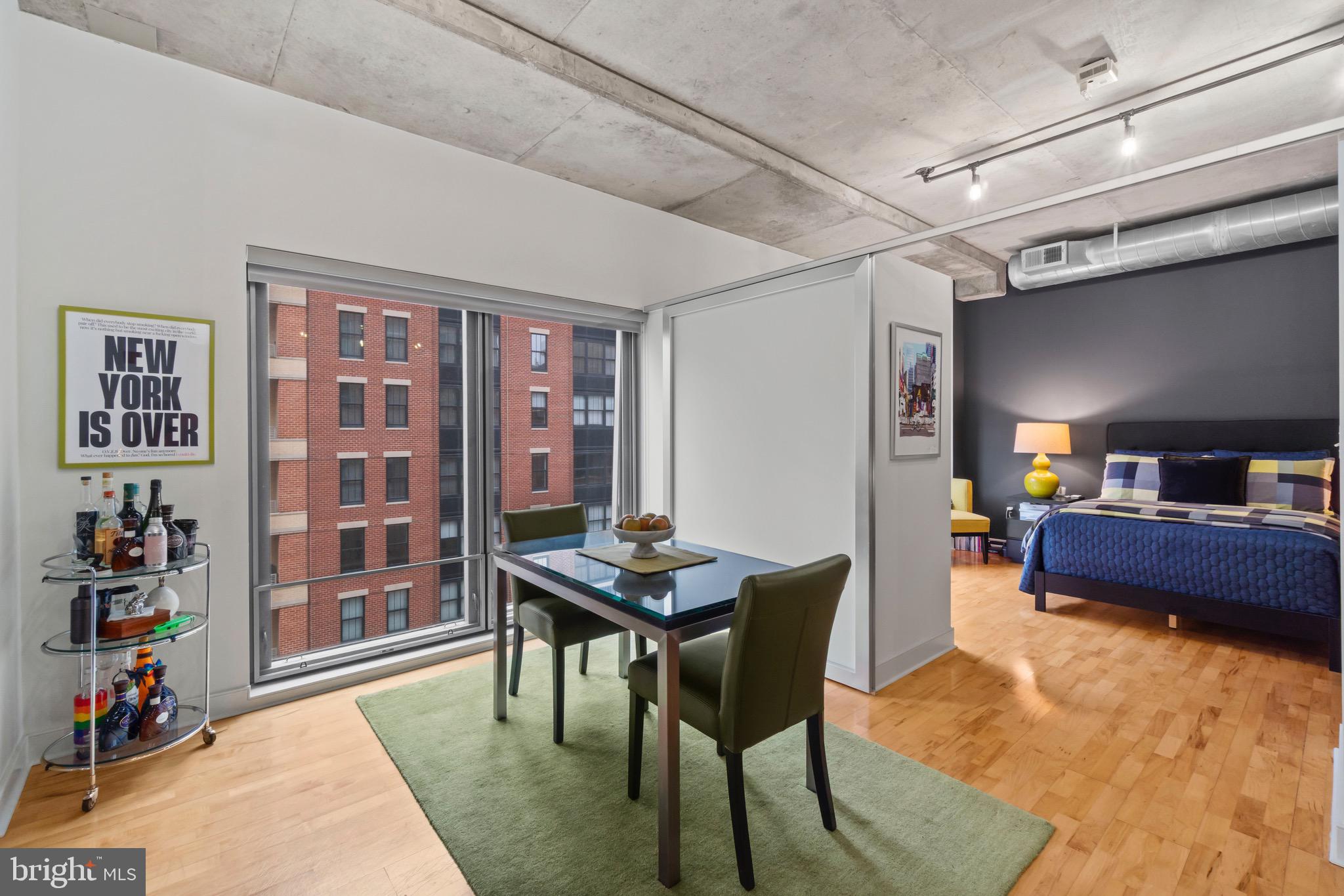 850 Aliceanna Street, Unit 604 Baltimore, MD 21202 - Photo 7 of 43 a bedroom with furniture and a book shelf