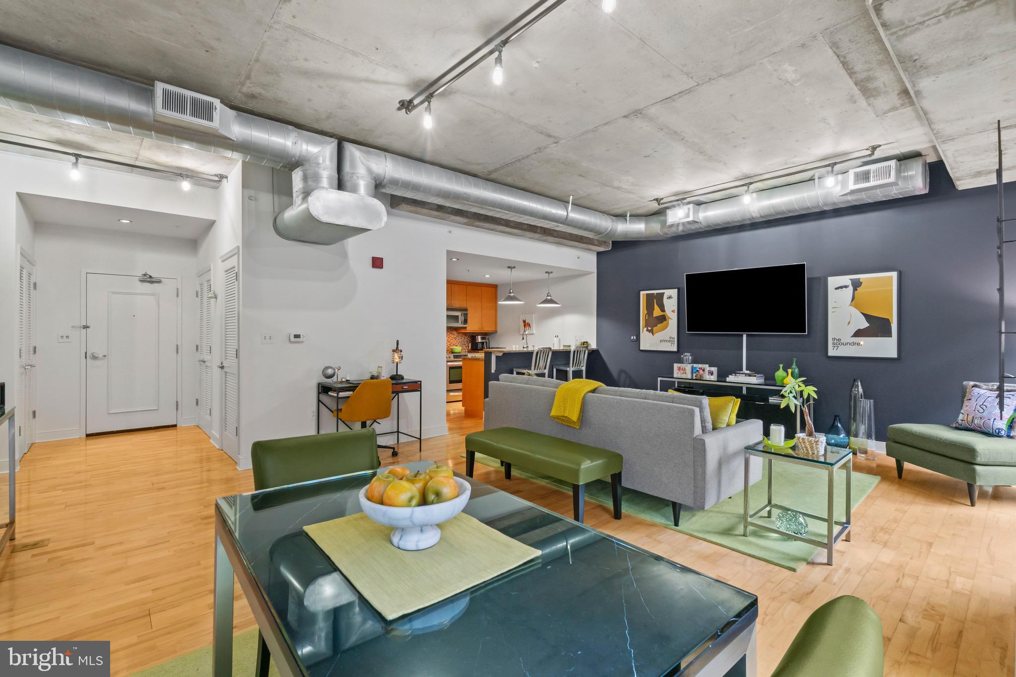 850 Aliceanna Street, Unit 604 Baltimore, MD 21202 - Photo 9 of 43 a living room with furniture and a flat screen tv