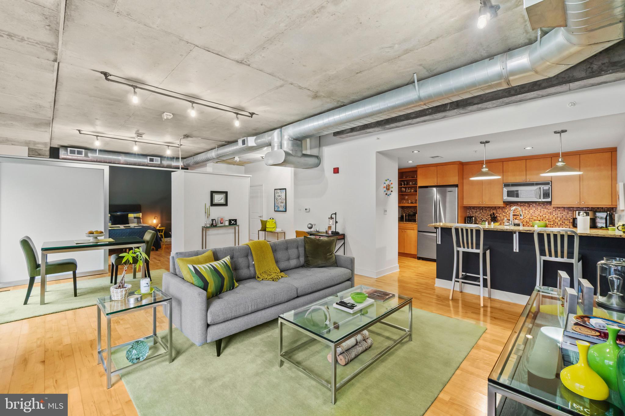 850 Aliceanna Street, Unit 604 Baltimore, MD 21202 - Photo 10 of 43 a living room with furniture and a view of kitchen