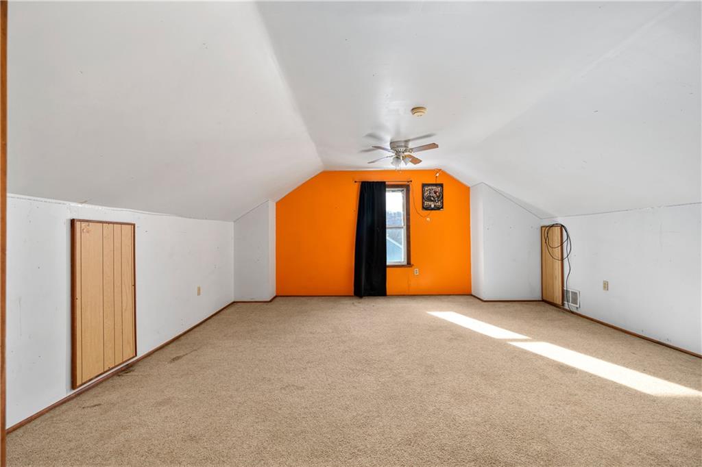 10 Alice Street McKees Rocks, PA 15136 - Photo 13 of 16 an empty room with a fireplace and chandelier