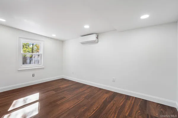 a view of room with window and wooden floor