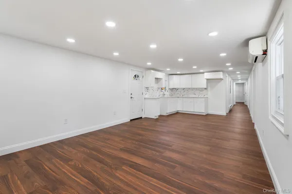 a view of kitchen with refrigerator and wooden floor