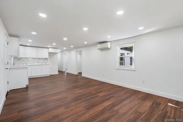 a view of a kitchen with wooden floor and a kitchen