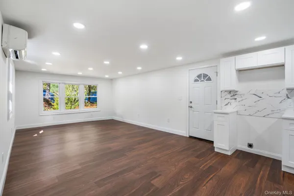 a view of a kitchen with wooden floor and window