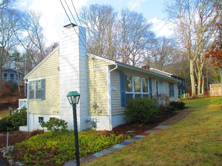 587 Shootflying Hill Road Centerville, MA 02632 - Photo 4 of 30 a front view of a house with garden