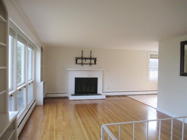 587 Shootflying Hill Road Centerville, MA 02632 - Photo 8 of 30 wooden floor fireplace and windows in an empty room