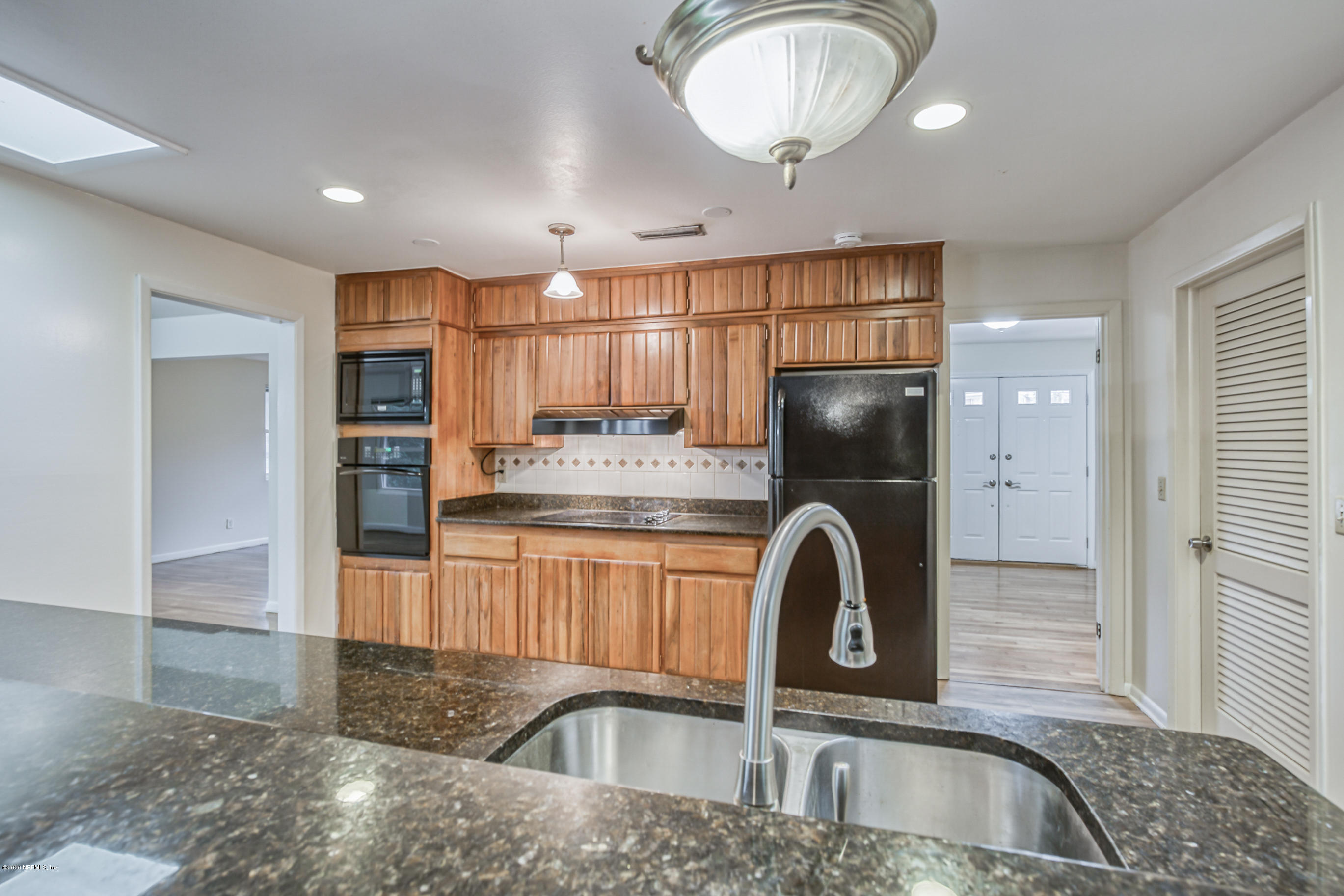 1305 Timber Lane Jacksonville, FL 32211 - Photo 12 of 58 a kitchen with kitchen island granite countertop a sink a stove and refrigerator